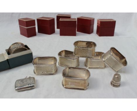 A set of six modern silver napkin rings, Sheffield, 1958, together with another napkin ring and a vesta case, approximately 2