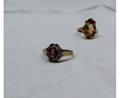 A ruby and diamond dress ring the central oval faceted ruby surrounded by eight diamonds to a 9ct yellow gold shank together 