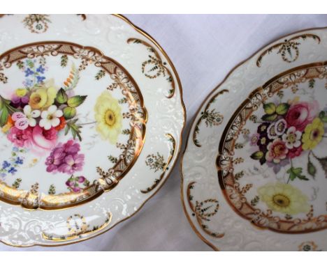 A pair of Swansea porcelain plates with a raised moulded rim with gilt and green highlights, the inner ring with gilt cross h