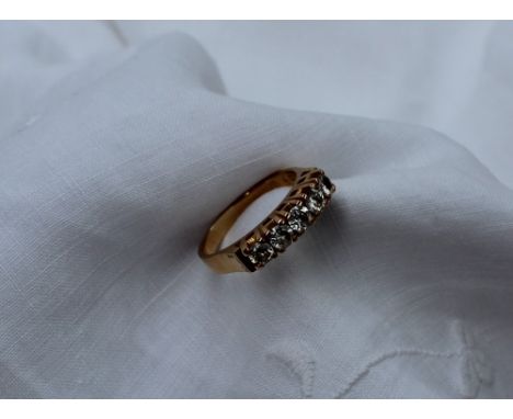 A five stone diamond ring set with round brilliant cut diamonds each approximately 0.20 of a carat,to yellow metal setting an