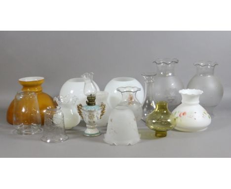 A good collection of oil lamp shades, globes and chimneys to include coloured, etched glass examples.