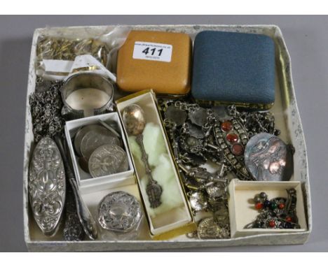 A tray of eastern white metal jewellery, commemorative medals, two travel alarm clocks and button hooks.