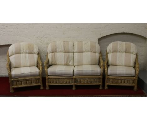 A bound and woven bamboo three part conservatory suite consisting of a two seater sofa and two matching armchairs.