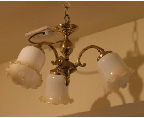 A brass and opaque glass three branch hanging lamp.