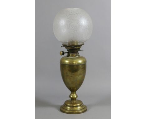 A Victorian brass based oil lamp with etched glass globular shade.