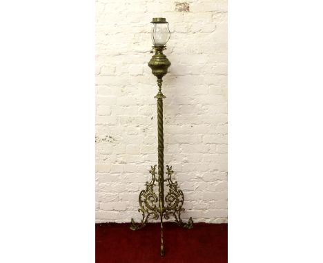 A large ornate Victorian gilt metal rise and fall oil lamp and shade.