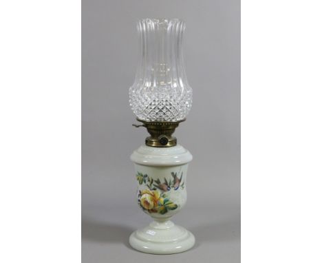 A Victorian opaque glass based oil lamp handpainted with flowers and birds along with a moulded glass shade.