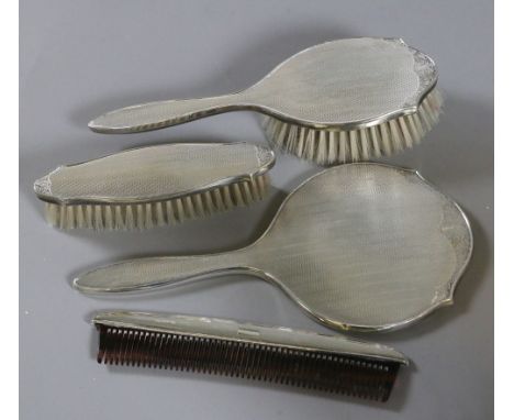 A silver backed brush set comprising mirror, hair brush, comb, clothes brush, assayed Birmingham.