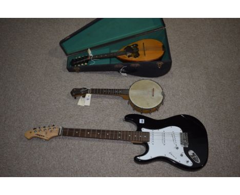 An Ariastg-Series electric guitar with black lacquer and white plastic mounted body, 98cms long; together with a ukulele banj