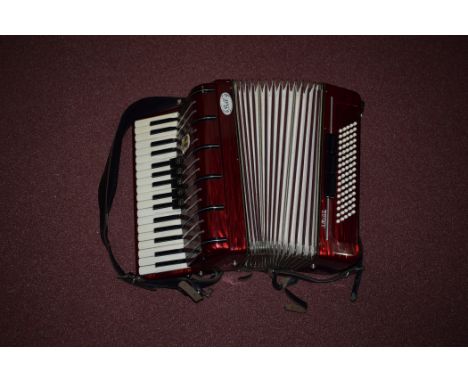 Am Amigo Bell piano accordion, in red wood effect plastic case, cased.