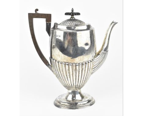 An Edwardian silver coffee pot by Walker &amp; Hall, Sheffield 1901, with part fluted body and lid, surmounted with an ebonis