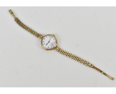 A 9ct yellow gold 1932 ladies wristwatch, the enamel dial with arabic numerals, with articulated bracelet, cm long, total wei