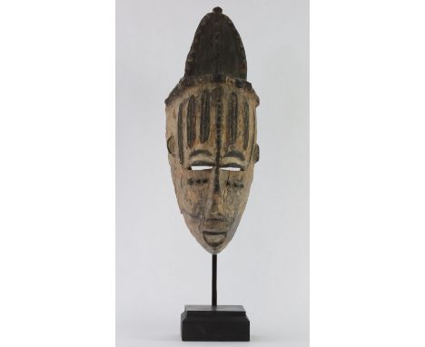 An Urhobo Mask, first half 20th Century        In distressed condition, missing parts, no horns.    Width 13,5 cm height 38 c