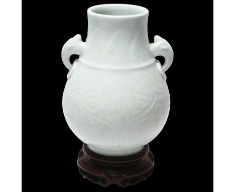 Chinese white glaze porcelain 2-handled vase, impressed geometric designs, seal mark under, on hardwood stand, height 24cmPer