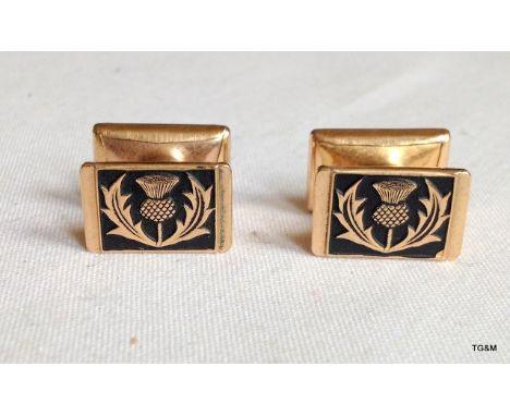 A pair of mens cufflinks depicting thistles
