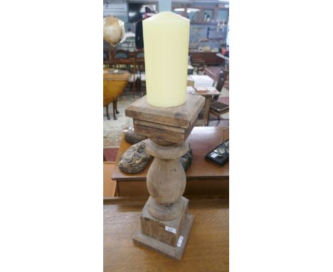 Large wooden candle stick with candle 