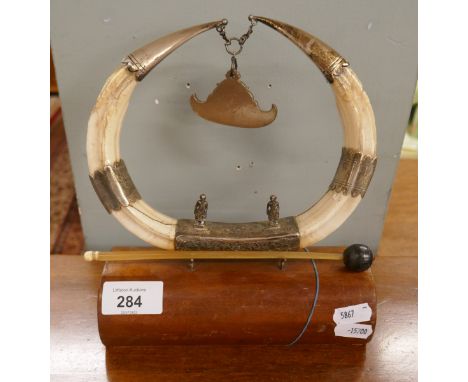 Boar tusk and white metal table gong 