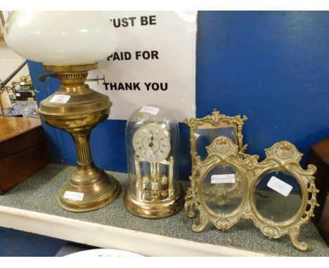 VICTORIAN BRASS OIL LAMP AND SHADE TOGETHER WITH A DOME TOP ANNIVERSARY CLOCK AND TWO BRASS EASEL BACK PHOTO FRAMES 