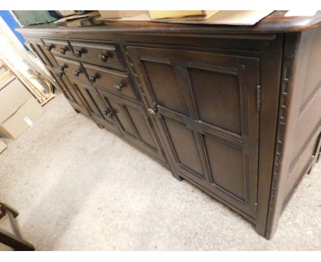 GOOD QUALITY LARGE ERCOL DRESSER FITTED CENTRALLY WITH FOUR DRAWERS OVER TWO CUPBOARD DOORS FLANKED EITHER SIDE WITH PANELLED