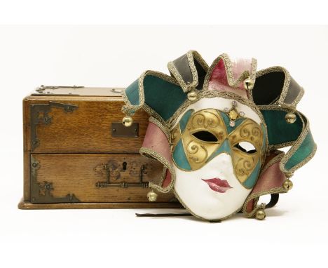 A late Victorian oak and brass bound smokers companion, together with a toilet mirror, a Venetian mask, and a Herbert Terry a