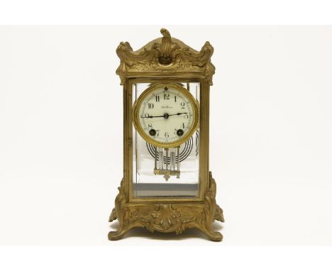 A Seth Thomas gilt metal four glass mantle clock with a mercury pendulum, 36cm high, together with a book 'Carriage clocks', 