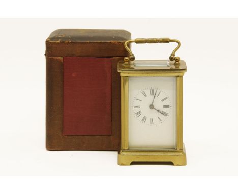 A late 19th century/early 20th century brass cased carriage clock, in a leather carrying case, with key