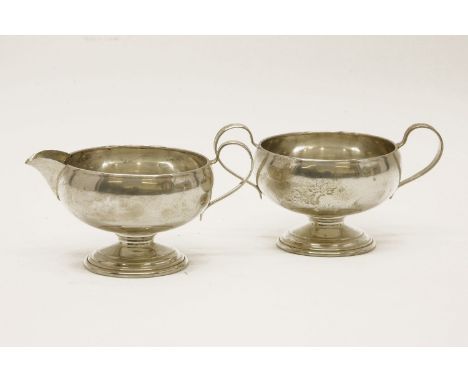 An American Frank M. Whiting & Co silver cream jug, together with matching twin loop handled sucrier