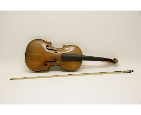 A late 19th century German copy of a Stradivarius violin, together with a bow, the two piece back measuring 357mm