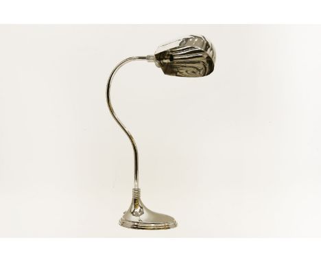 A nickel plated students lamp, the shell form shade on adjustable column and stepped base, 54 cm high, silver plated