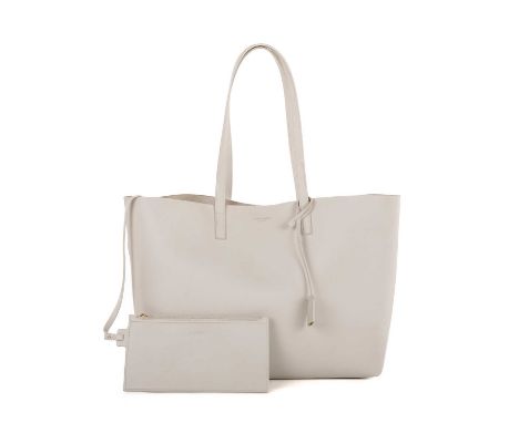Saint Laurent, a large tote with pouch, crafted from pale grey leather, featuring dual flat leather handles with hanging cloc