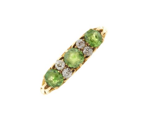 An Edwardian 18ct gold demantoid garnet dress ring, with old-cut diamond double spacers, estimated total diamond weight 0.20c