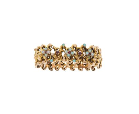 A late Victorian 9ct gold expanding bangle bracelet, with ruby and opal highlights, inner diameter 4 to 8cm, 12.5gOverall goo