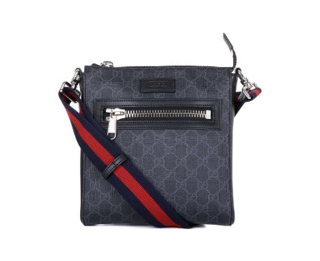 Gucci, a black supreme messenger bag, crafted from the maker's black and grey GG monogram coated canvas with smooth black lea