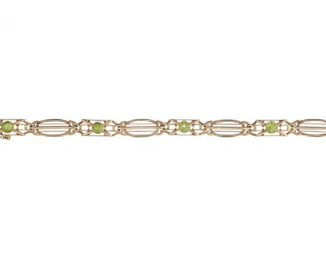 An Art Nouveau 15ct gold peridot openwork bracelet, stamped 15ct, length 18.5cm, 16.6gOverall good conditionPeridots are a sl