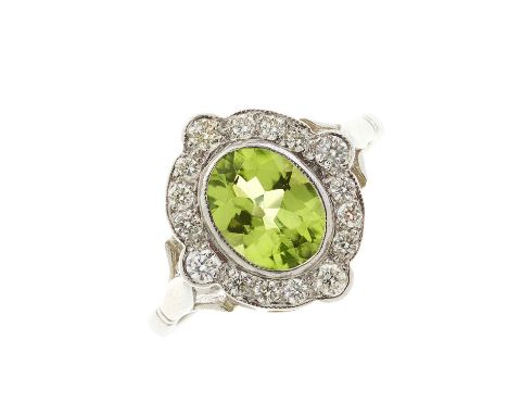 A platinum peridot and diamond cluster dress ring, peridot estimated weight 1.35ct, estimated total diamond weight 0.30ct, st