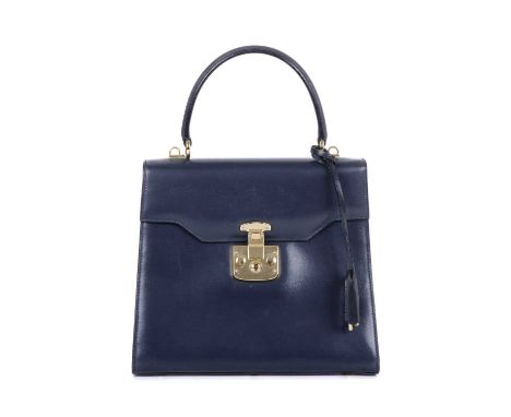 Gucci, a Lady Lock handbag, designed with a structured shape, featuring a navy blue leather exterior, polished gold-tone hard