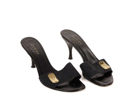 Gucci, a pair of monogram mules, crafted from the maker's black GG canvas, with gold-tone signature side nameplate, and taper