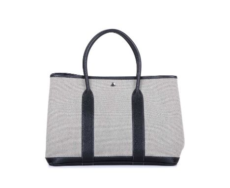 Hermes, a 2006 limited edition Garden Party MM tote, crafted from grey toile canvas with black leather trim, featuring silver
