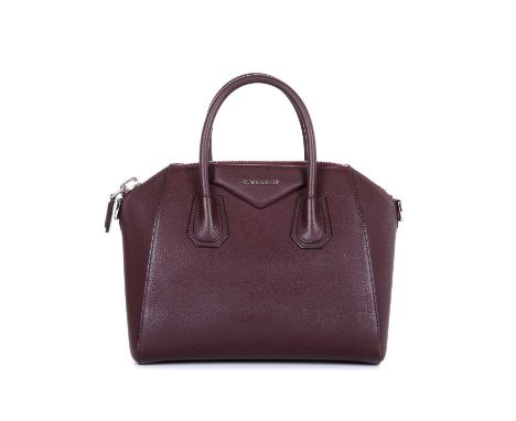 Givenchy, a small Antigona handbag, designed with a grained burgundy leather exterior, with a triangular patch featuring the 