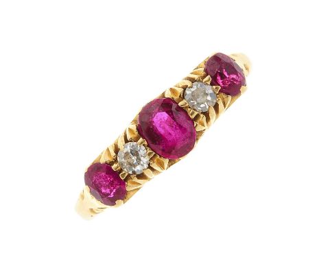 An early 20th century 18ct gold graduated ruby three-stone dress ring, with old-cut diamond spacers, estimated total diamond 