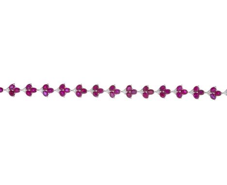 An 18ct gold ruby and brilliant-cut diamond foliate line bracelet, estimated total ruby weight 12ct, estimated total diamond 