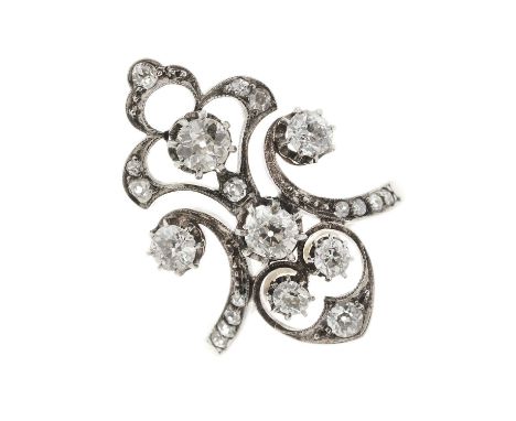 A late Victorian gold and silver, old-cut diamond dress ring, of openwork scrolling design, estimated total diamond weight 0.
