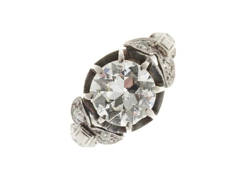 A mid 20th century platinum circular-cut diamond single-stone ring, with vari-cut diamond accent shoulders, estimated total d