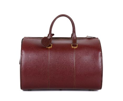 Cartier, a large vintage Bordeaux travel bag, crafted from burgundy leather, with gold-tone hardware, rolled leather handles 