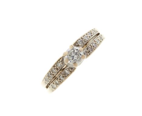 An 18ct gold and platinum brilliant-cut diamond ring, with similarly-cut diamond sides, principal diamond estimated weight 0.