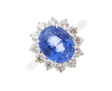 An 18ct gold sapphire and diamond cluster ring, sapphire estimated weight 3.20ct, estimated total diamond weight 0.80ct, I-J 