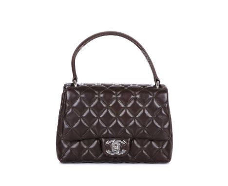 Chanel, a quilted Top Handle handbag, crafted from brown quilted lambskin leather, with a single leather top handle, rear pat