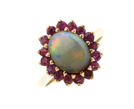 A gold opal cabochon and ruby cluster dress ring, ring size N, 4.4gOverall good conditionLength of ring head 1.5cmOpal is whi