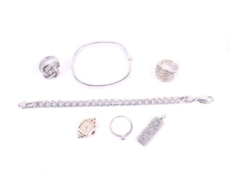 An assortment of white metal jewellery and a lady's 9ct gold Chalet watch. The jewellery including a silver ingot, silver ban