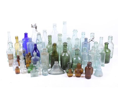 A collection of British vintage glass bottles. Of various sizes, colours and shapes, including green, clear, amber and blue e